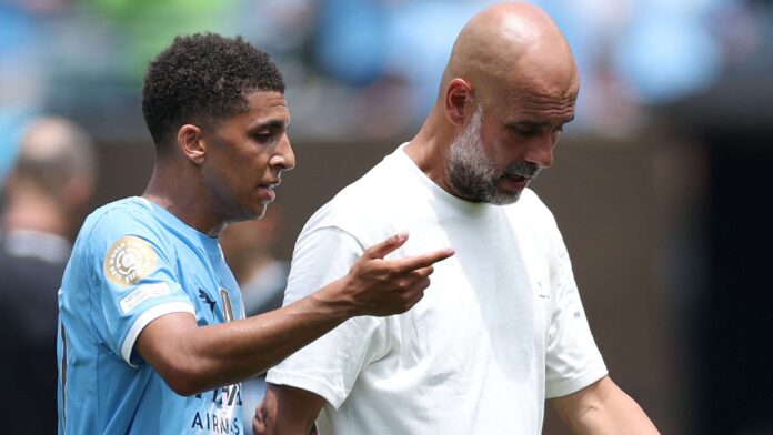 Rico Lewis and Pep Guardiola